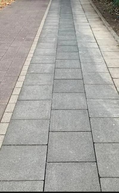 Wiederhergestellter Gehweg aus Betonplatten nach der Leitungsverlegung